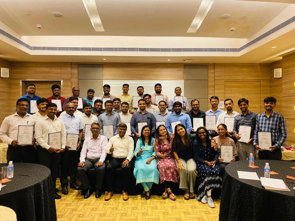 Bhavani with a leadership workshop group holding completion certificates
